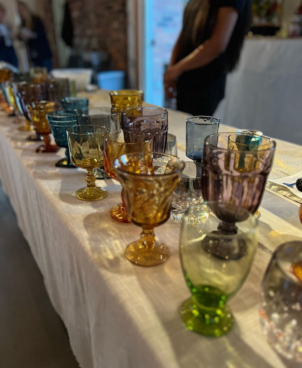 Colored, vintage glassware laid out at a party in Buffalo, NY